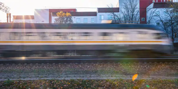 The train is gaining speed for movement by rail. Locomotive blurred.