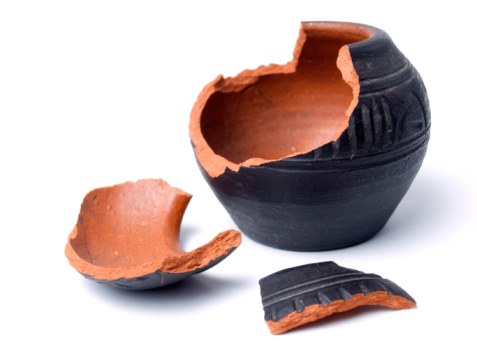 A broken red clay pot isolated on a white background