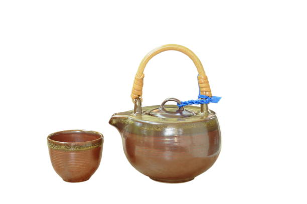 istock pottery tea pot and glass on white background 1064156284