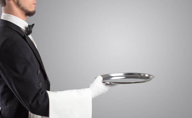 istock Waiter serving with white gloves and steel tray 1064157390