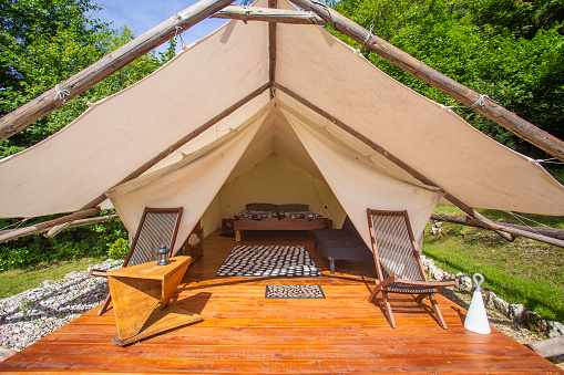 Glamping tent exterior with all amenities in Adrenaline Check eco camp in Slovenia.