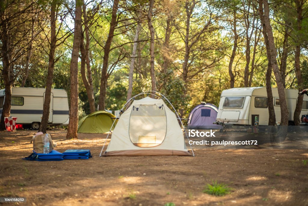 View of tent in camp ground. View of tent in camp ground in the middle of pine forest. Camping Stock Photo