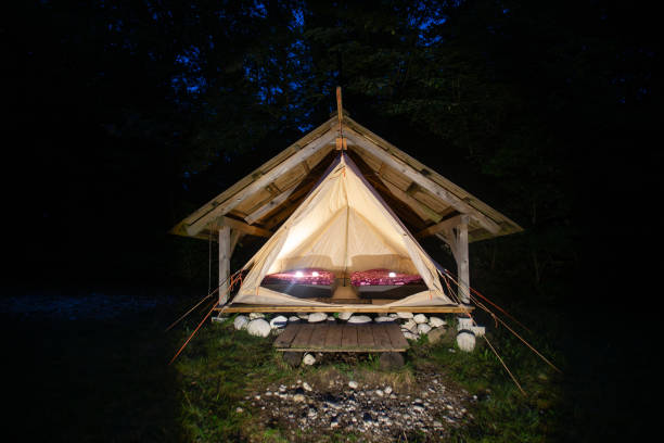 night shot of illuminated tents in adrenaline check eco camp, slovenia. - home interior cabin shack european alps imagens e fotografias de stock