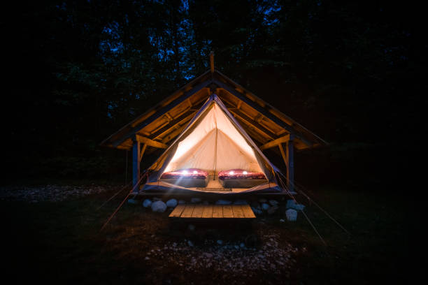 night shot of illuminated tents in adrenaline check eco camp, slovenia. - home interior cabin shack european alps imagens e fotografias de stock