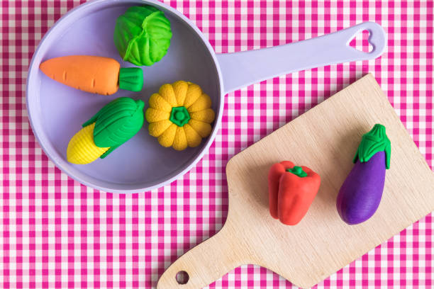 istock Flat lay of various vegetables in pan and on cutting board abstract against red classic checkered tablecloth texture. 1064161400