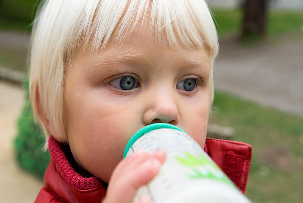 istock Young girl with feeding bottle 106416151