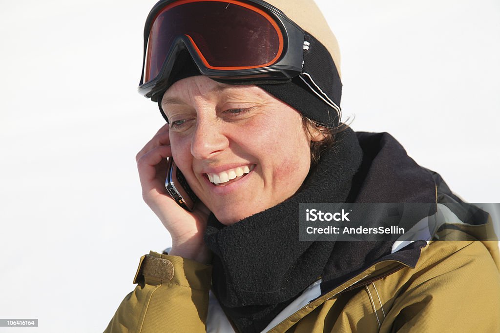 women talking in mobile phone skipiste  Adult Stock Photo