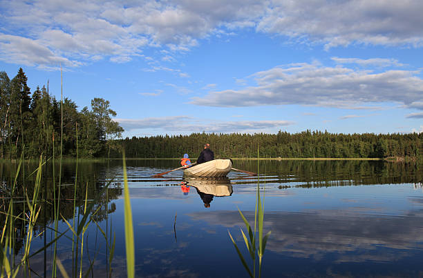 barca a remi sul lago con padre e figlio - sweden fishing child little boys foto e immagini stock