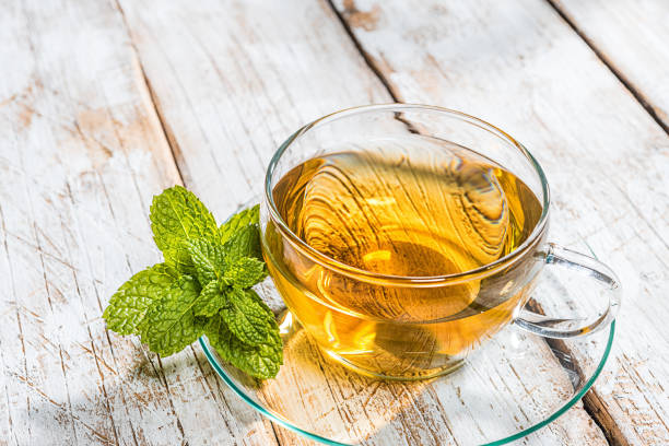 istock Glass cup of tea on old wooden table 1064163520