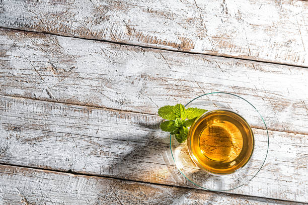 istock Glass cup of tea on old wooden table 1064163654