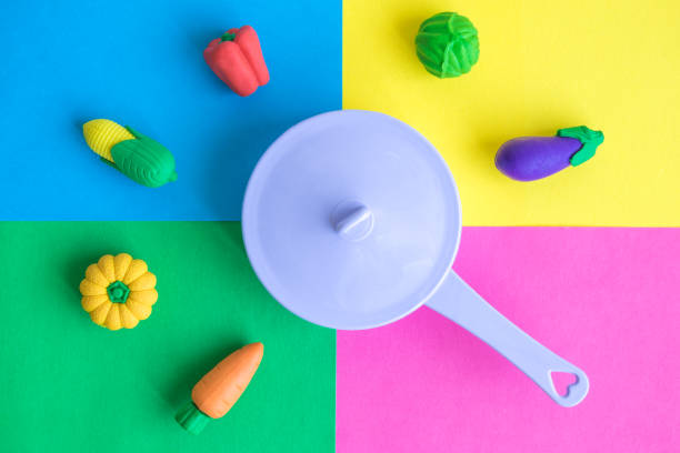 istock Vegetables and saucepan abstract against multicolored background. 1064163932