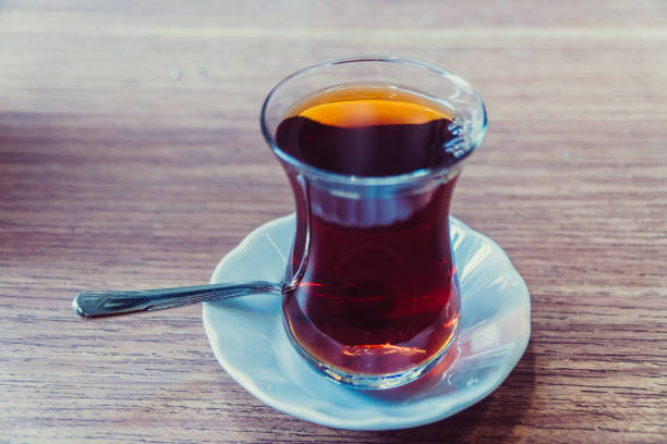 istock Tea. Turkish tea on the background of hands with a mobile phone 1064164996