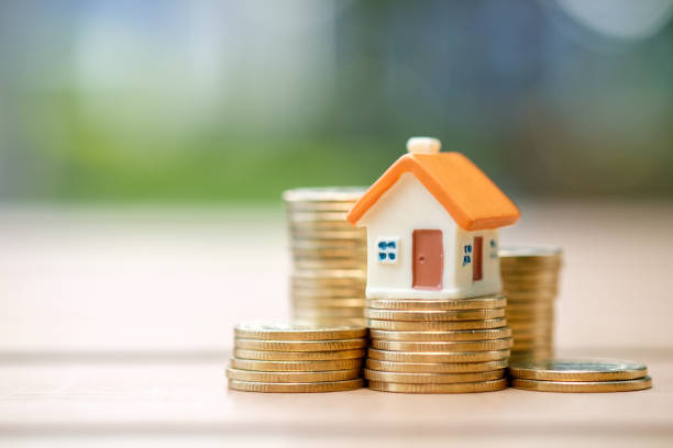 House and coins stack. Mini house on stack of coins. Concept of Investment property. money house stock pictures, royalty-free photos & images