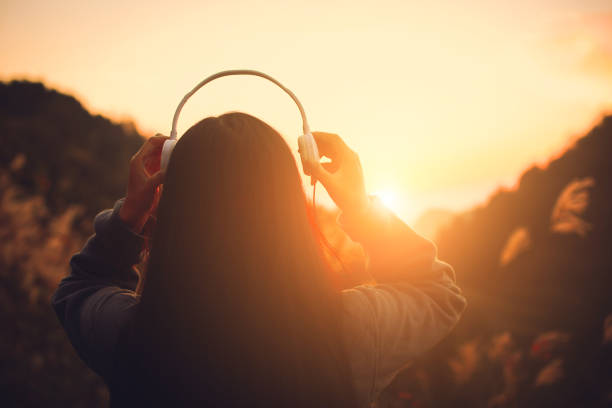 istock Young woman with headset at sunset 1064169798