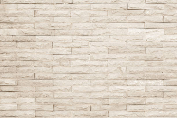 istock Seamless cream pattern of decorative brick sandstone wall surface with concrete of modern style design decorative uneven have cracked realmasonry wall of multicolored stones or blocks with cement. 1064173376
