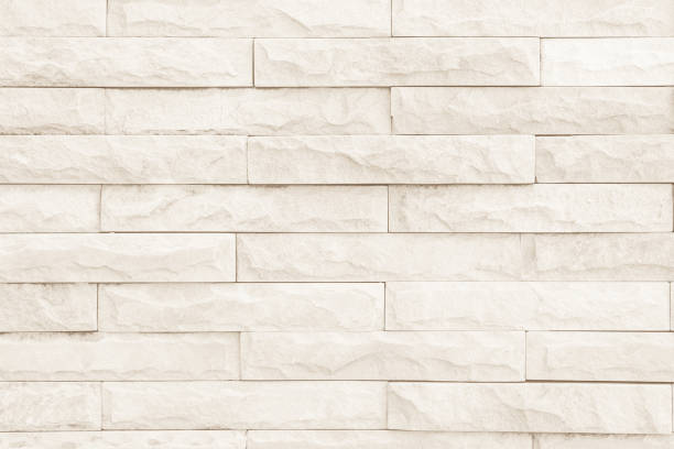 istock Seamless cream pattern of decorative brick sandstone wall surface with concrete of modern style design decorative uneven have cracked realmasonry wall of multicolored stones or blocks with cement. 1064173382