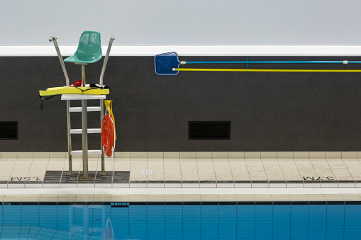 Public swimming pool with lifeguard chair