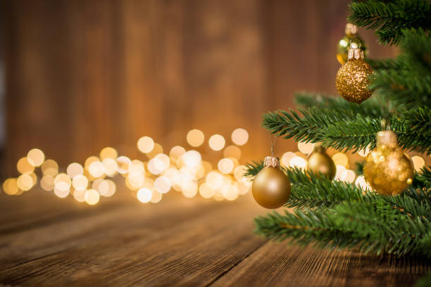 istock Fir Tree decorated with christmas balls on rustic wood and sparkles light backgorund 1064187426
