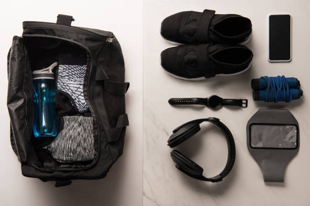 flat lay with sports bag and arranged sports equipment on white and marble - gym bag imagens e fotografias de stock