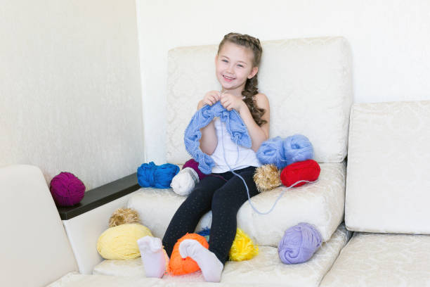 istock The girl knits with knitting and thread. 1064193010