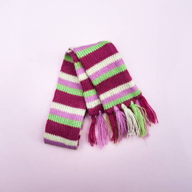 istock Knitted multicolored scarf on a plain background. Minimalism, View from above, flat lay 1064193154