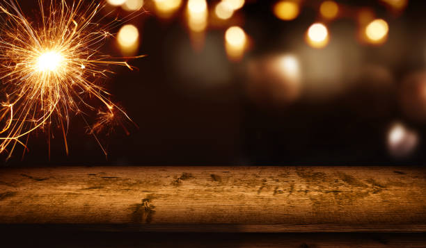 istock Christmas background with wooden table and sparkler 1064195522