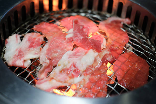 istock Sliced meat grill on iron rack (close up) 1064196274