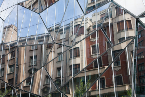The facade of the old town hall in Laakirchen is reflected in the glass facade of the new town hall - Laakirchen is a large paper industry location in Upper Austria