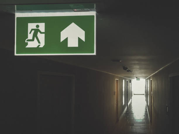 istock Emergency fire exit green sign at the corridor in office building., close up at the signs. 1064202532