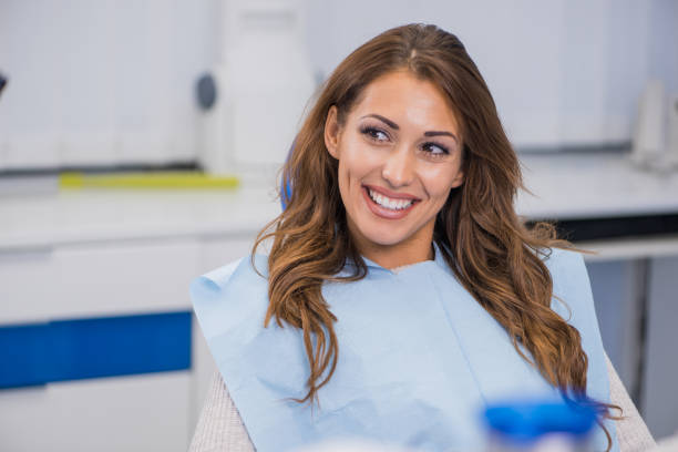 istock Young female patient talking with her dentist 1064202924