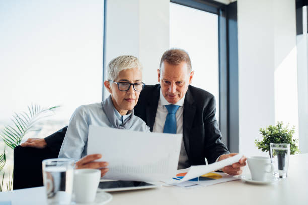 istock Business people revising paperwork 1064205054