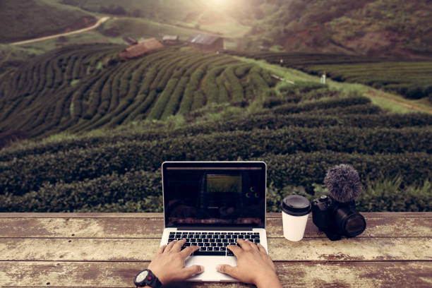 istock Top view creator or editor working use on laptop outdoor in green tea fields 1064205518