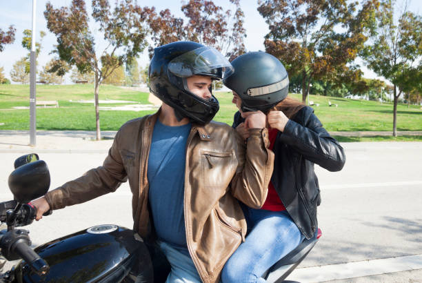 istock Boy helping to put the motorcycle helmet 1064208228