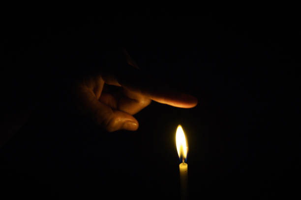 istock The hand that protects the candles in the dark. 1064209286