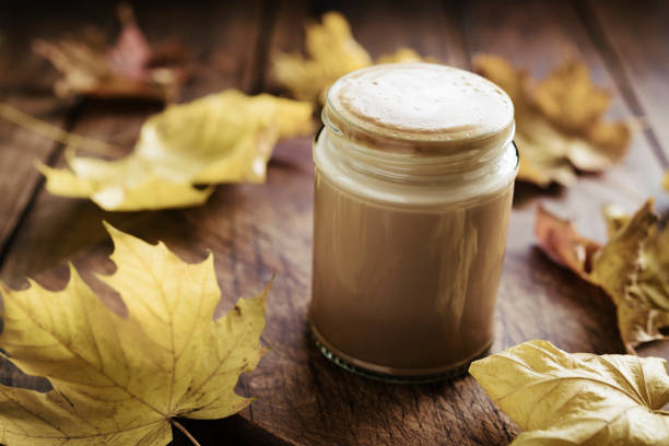 istock Latte Coffee served in a Mason Jar surrounded by Autumn leaves. 1064211794