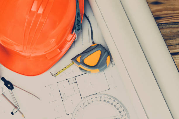 istock Helmet and measurement tool on blueprint, architectural concept 1064215226