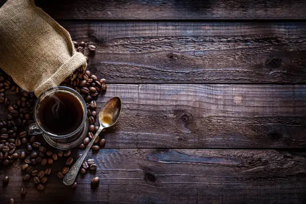 Photo of Coffee backgrounds: coffee cup on rustic wooden table with copy space