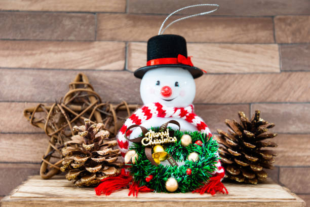 istock Snowman with Christmas decoratio on wooden background 1064220514
