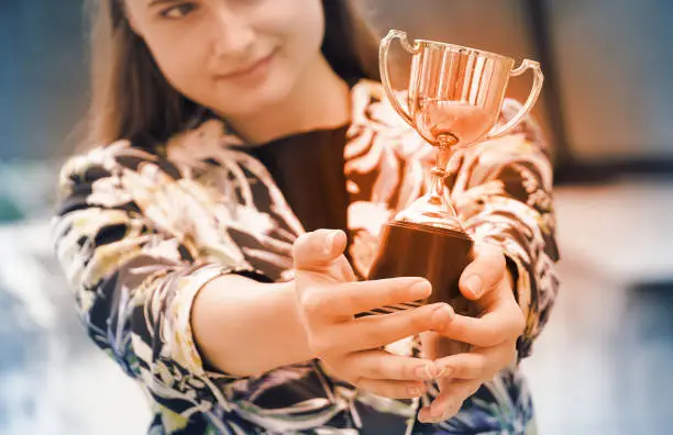 Photo of Business woman show trophy,win concept.