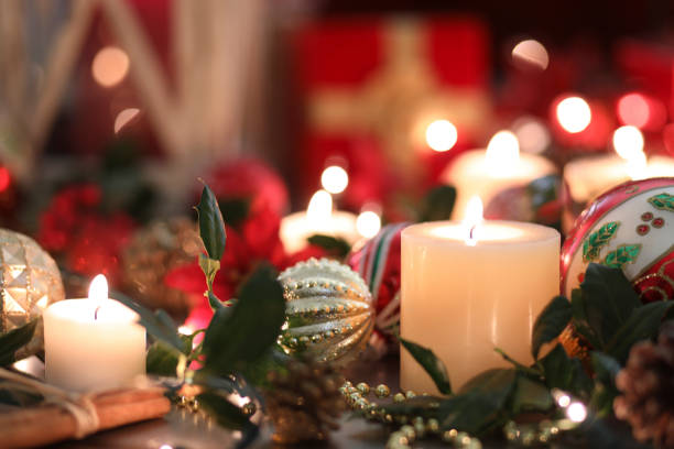 christmas holiday decorations, candles on table. - poinsettia christmas candle table imagens e fotografias de stock