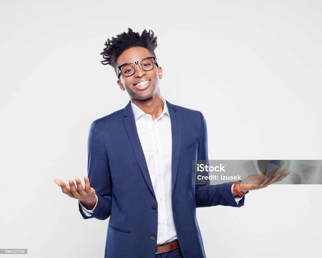 Good looking afro american businessman Portrait of good looking young afro american businessman gesturing with both hands  and smiling on gray background. Cut Out Stock Photo