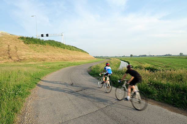 istock Two cyclists in Dutch polder landscape during summer 106422711