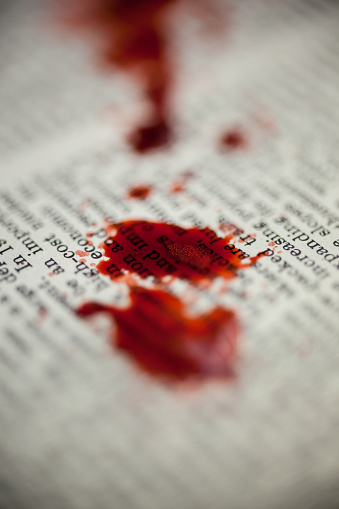 Blood spatter is seen on a vintage encyclopedia.