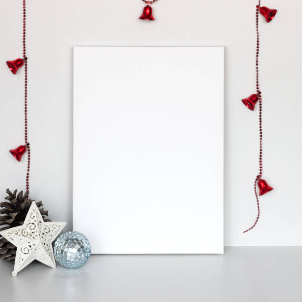 istock Blank canvas lean at white wall with Christmas decor. 1064229176