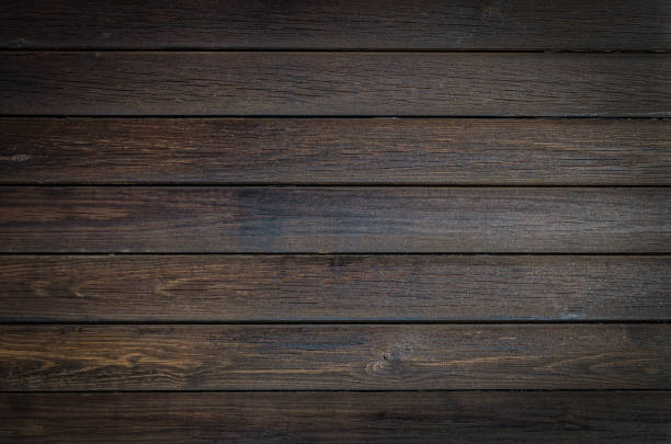 istock Dark brown wooden background, horizontal plank texture. 1064232534