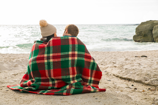 Young couple sitting on beach