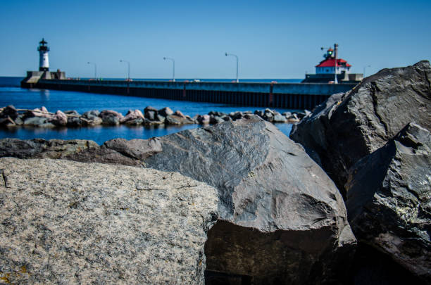istock Rocks in foreground in focus with intentionally blurred lighthouses in background 1064232880