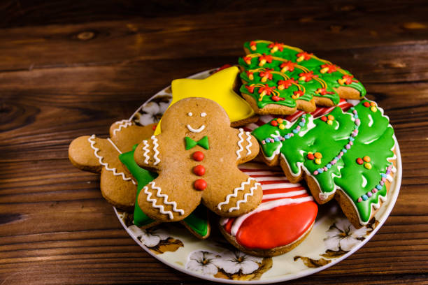 istock Plate with different christmas gingerbread cookies on wooden table 1064233006