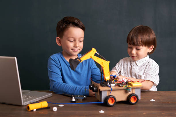 istock Two children builds robot together 1064239736