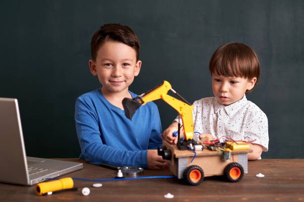 istock Two children builds robot together 1064239938